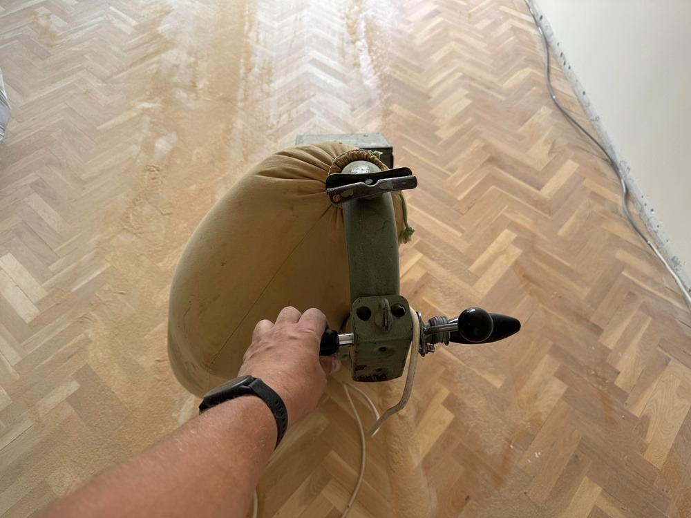 Professional parquet floor sanding using a commercial floor sanding machine, restoring a herringbone wood floor in Tonbridge TN9.